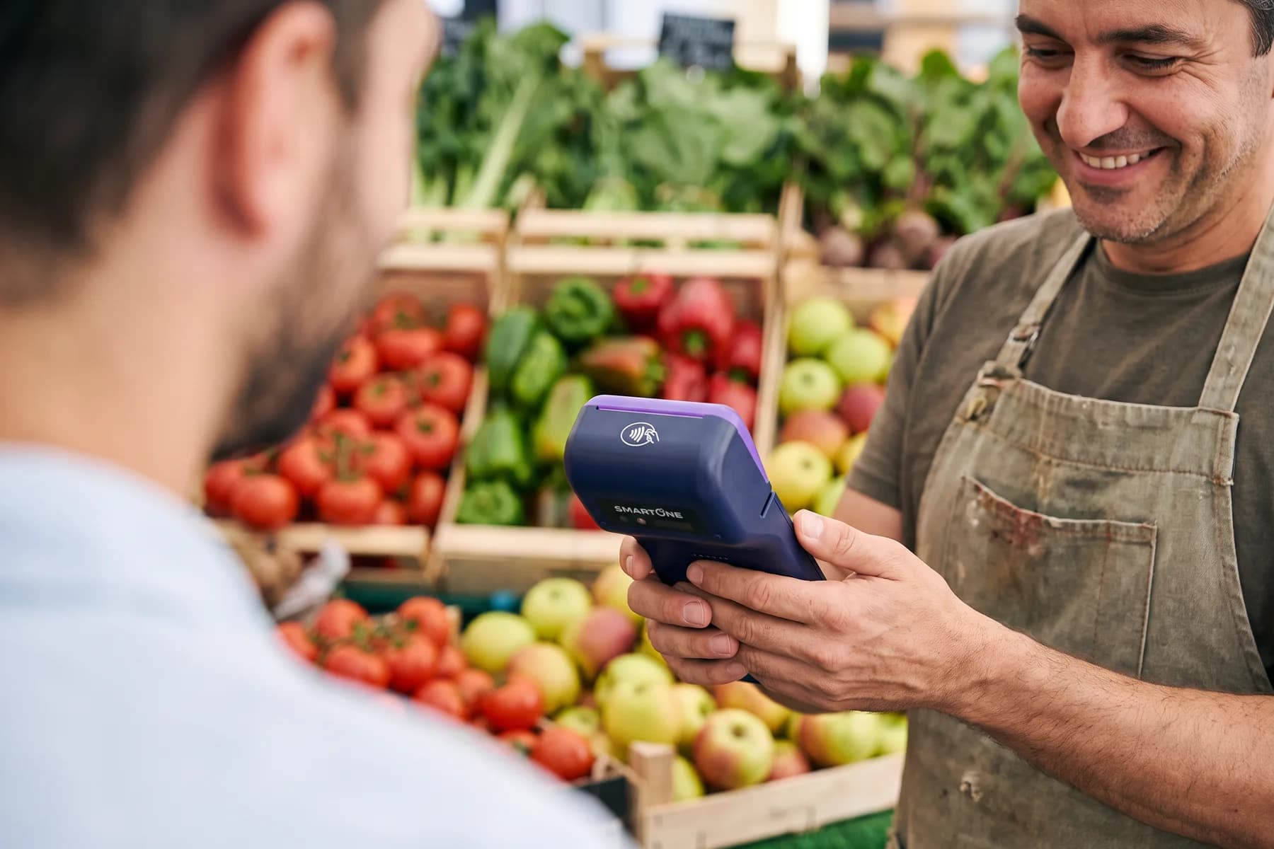 Merchant taking a contactless card payment on a SmartOne terminal